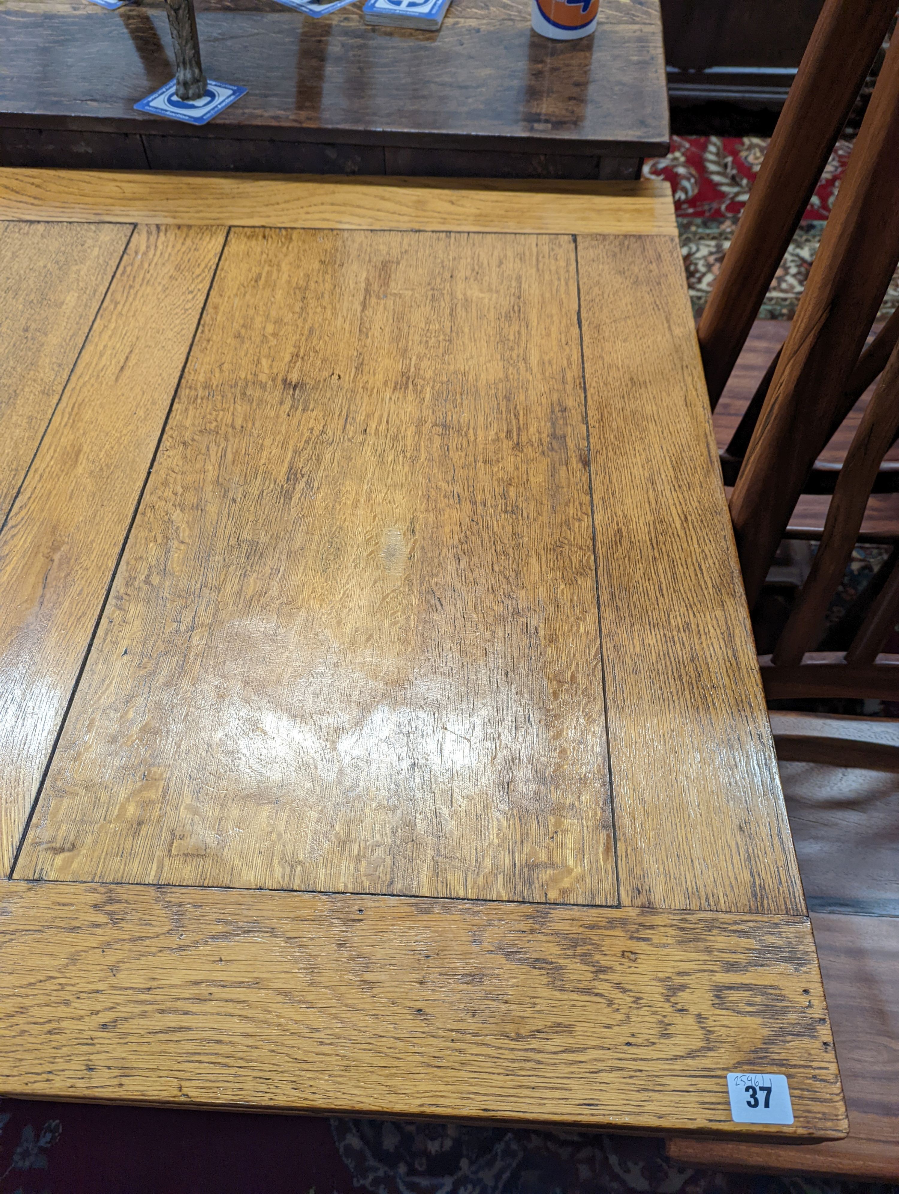 An 18th century style pale oak draw leaf dining table on carved baluster legs, length 242cm extended, depth 91cm, height 75cm